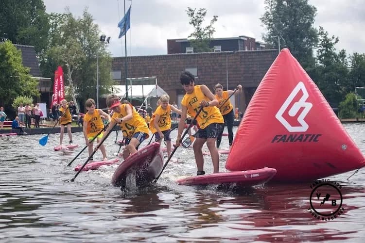 Academy athletes in race jerseys turning the buoy on race day