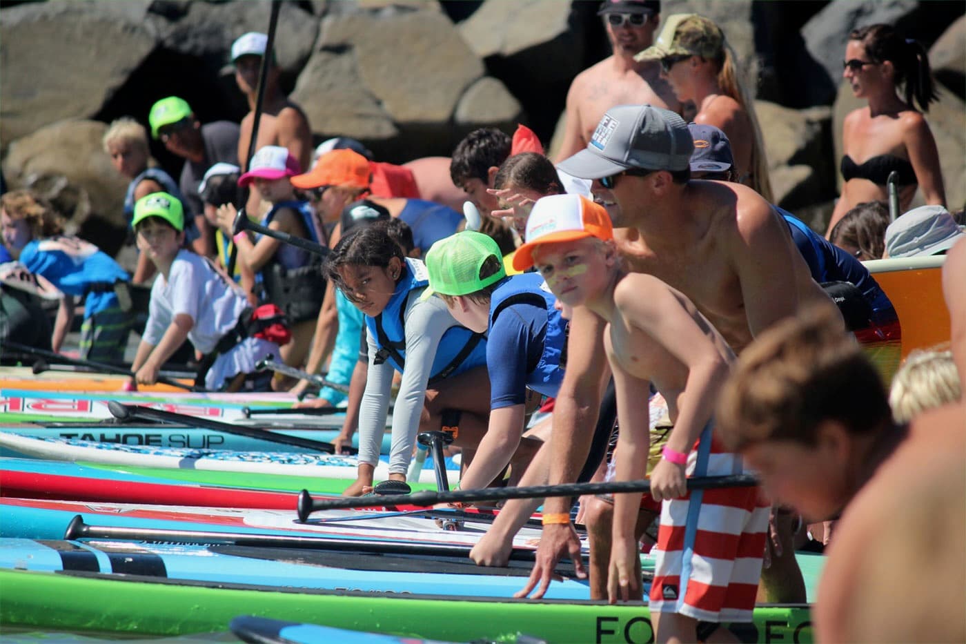 Younger paddlers in life jackets ready to launch