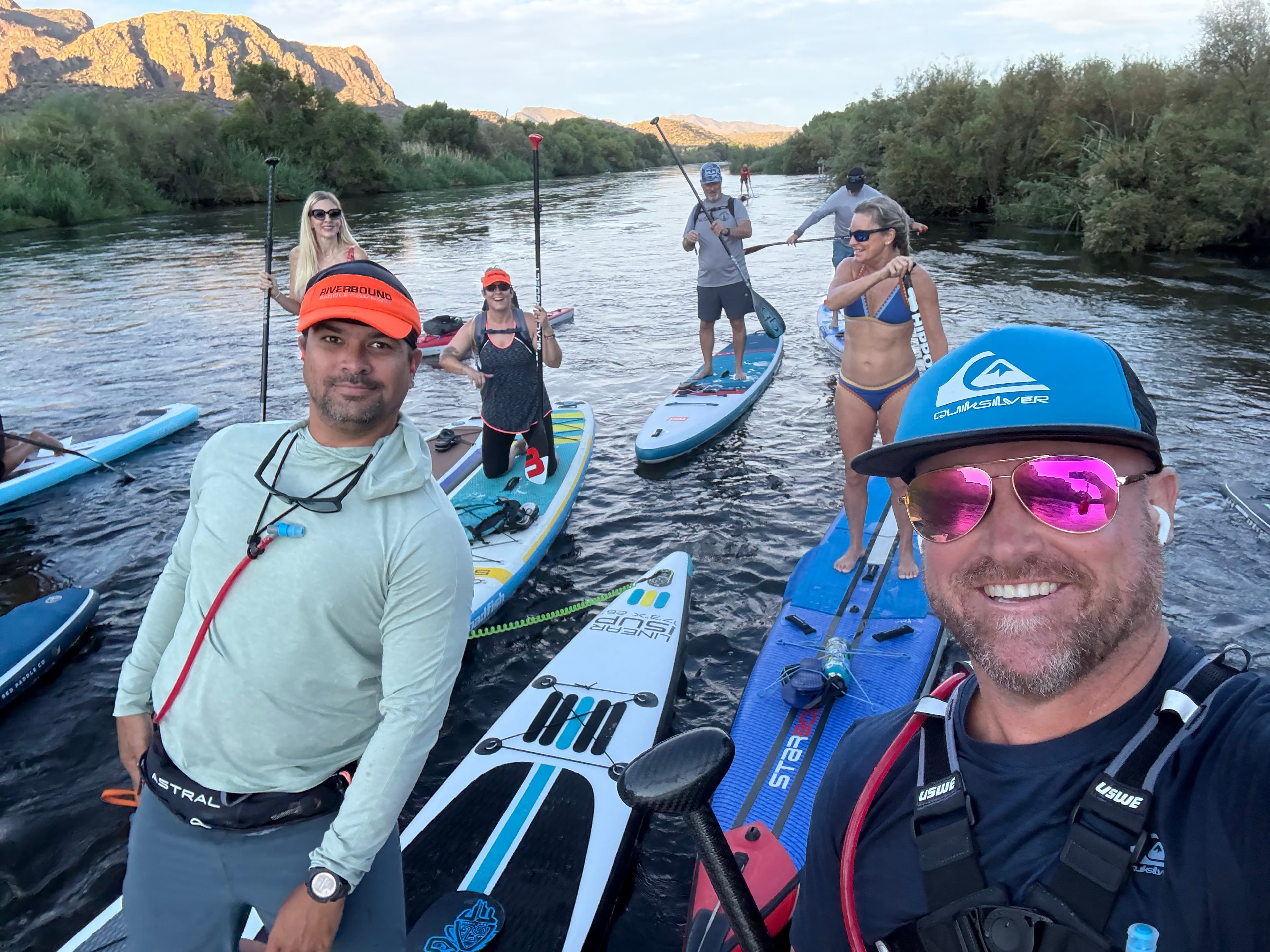 Salt River team group photo with desert canyon walls behind