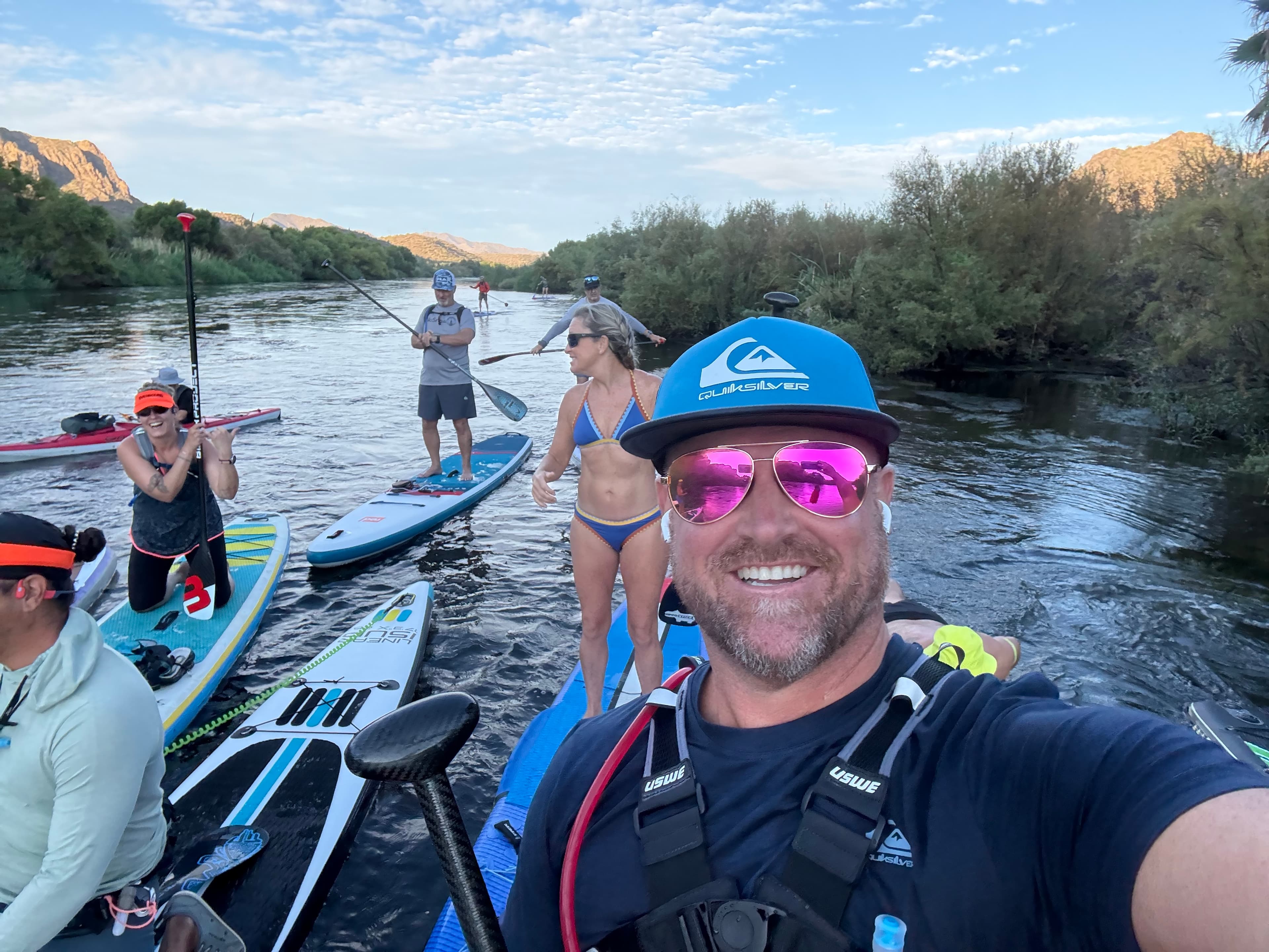 Arizona SUP Academy cohort paddling the Salt River canyon at golden hour