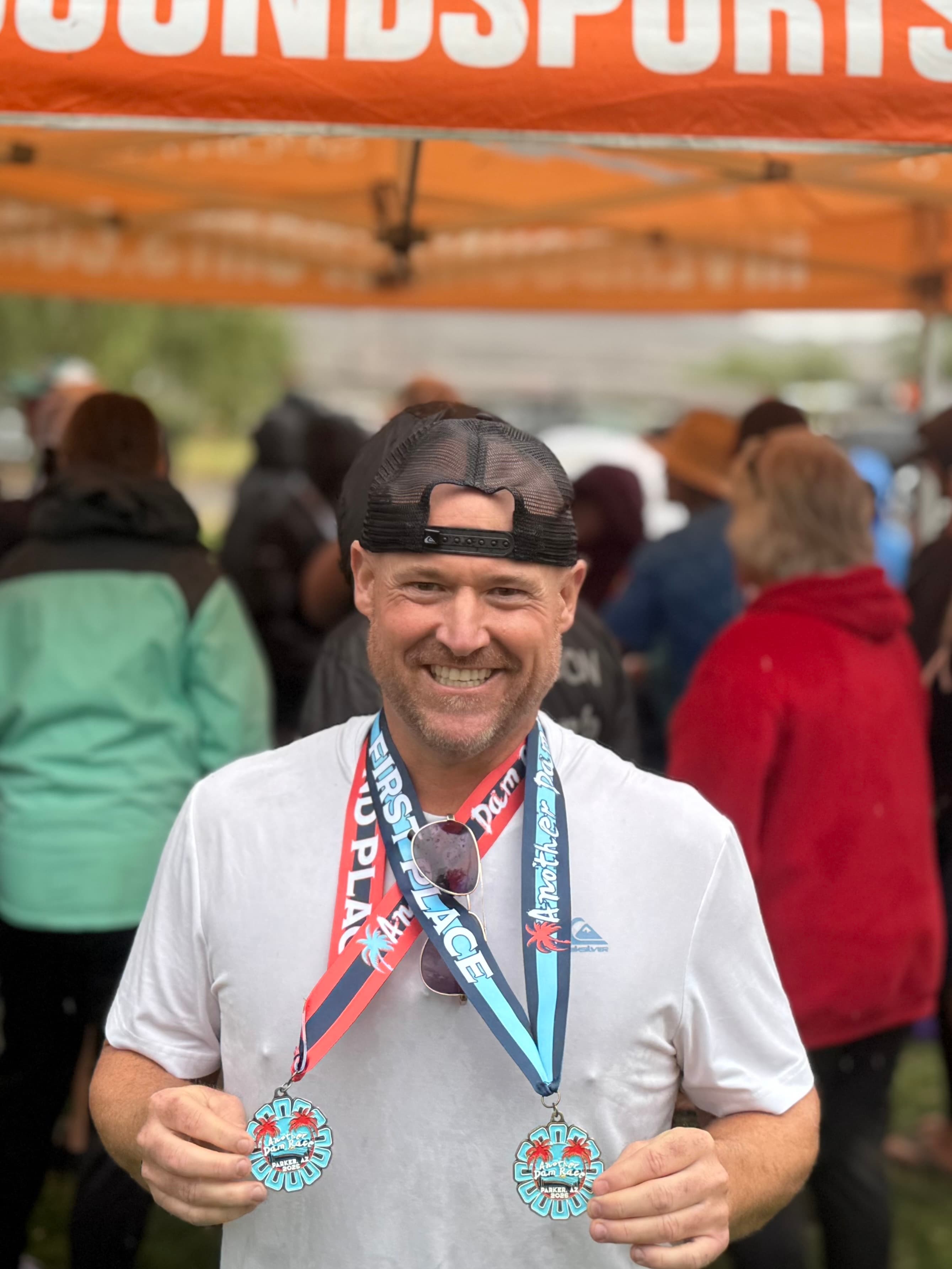 Founder Joshua Vincent at the Riverbound podium with two first-place medals