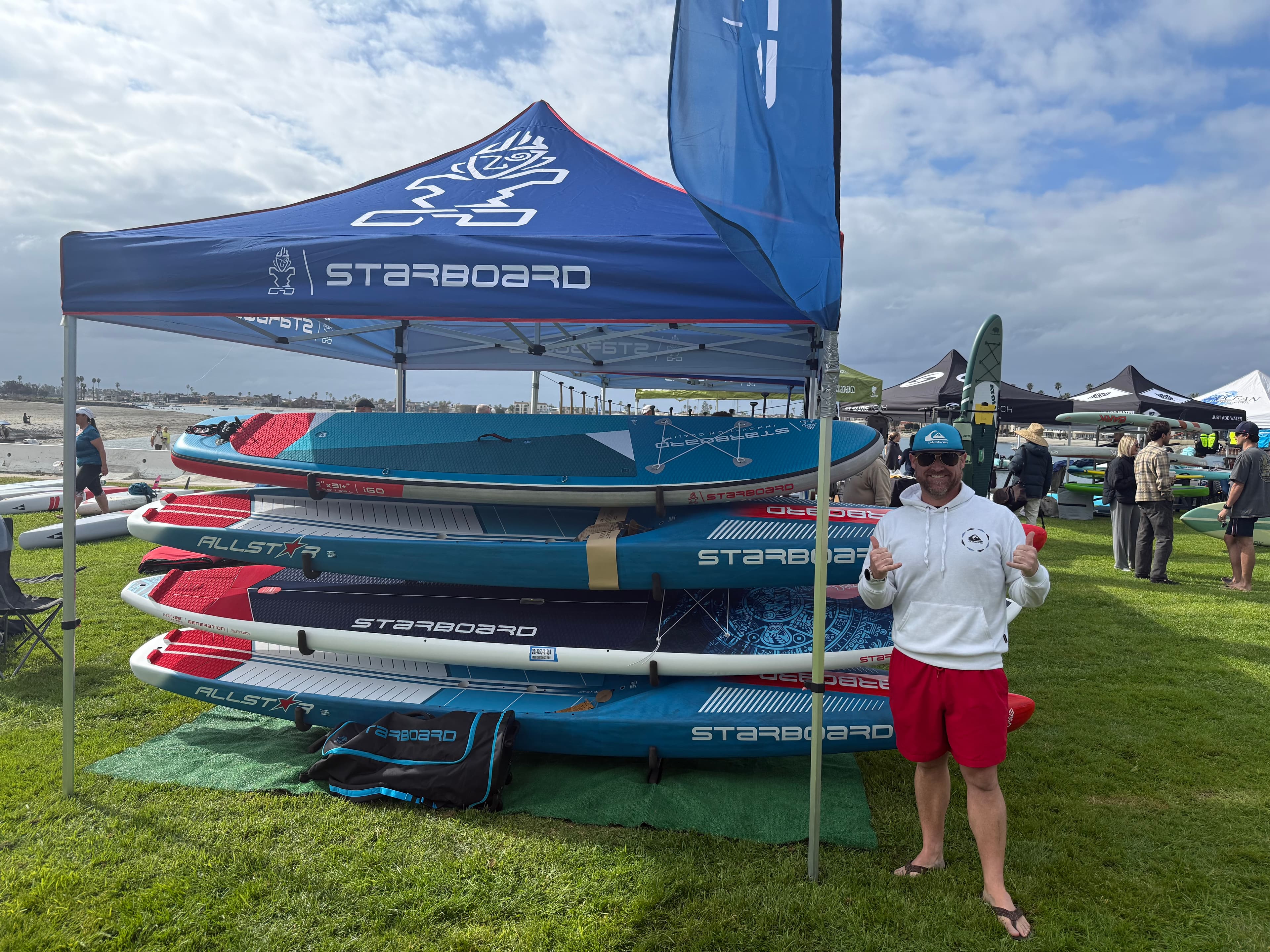 Credentialed instructor with the race-board quiver at a sanctioned event